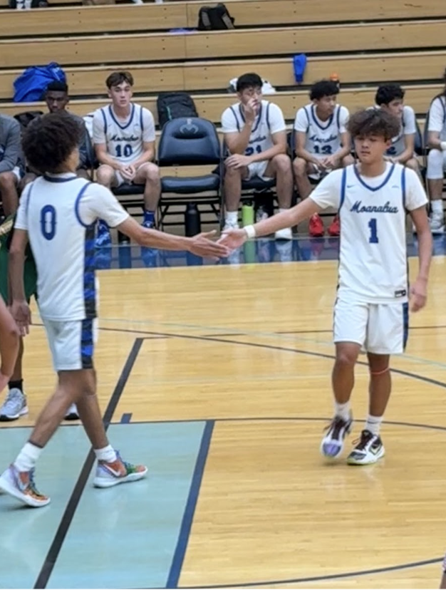 Senior Guard Tramir Ladipo and Junior Guard Dylan Sogawa high-five after a free throw.